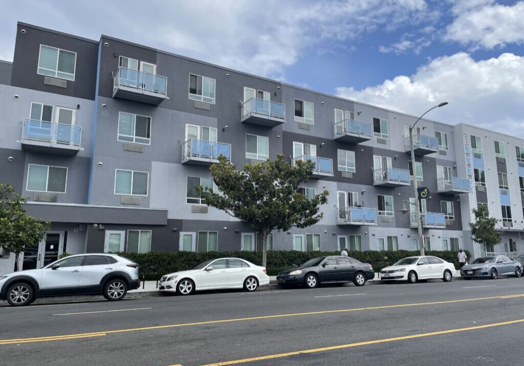 A row of parked cars on the side of a building.